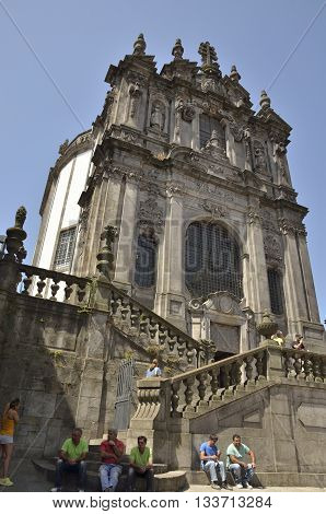 PORTO, PORTUGAL - AUGUST 10, 2016: People sitting in front of the Clerigos church in Porto Portugal