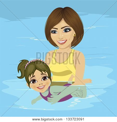 beautiful young mother teaching her little girl how to swim at a swimming pool