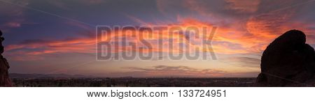 Panorama of sunset over late evening red sky over Phoenix,Arizona.  Papago Park buttes in foreground.