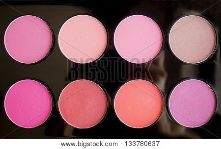 Colorful blush set with dry texture. Palette of professional cosmetics. Artistic retouching.