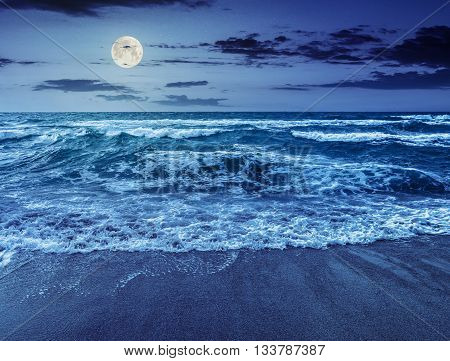 Sea ​​waves Running On Sandy Beach At Night