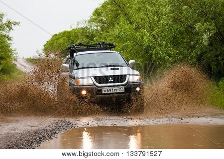 NIKOLAEVKA RUSSIA - JUNE 11 2016: Mitsubishi Pajero moving by water making lots of splashes