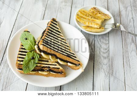 Sweet sandwich with chocolate and grilled banana