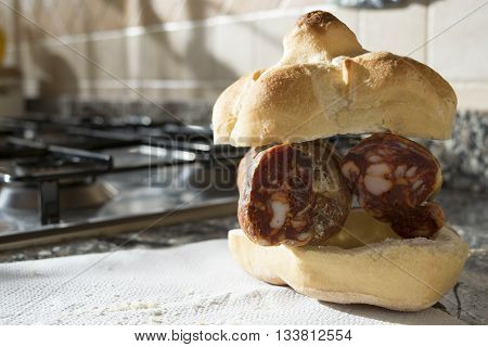 typical italian rosetta or roll filled with soppressata salami