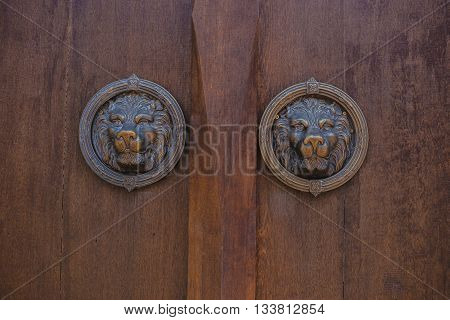 metal antique door knocker shaped like a lion's head.