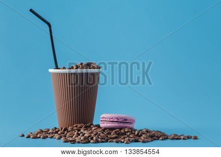 Paper cup with Sleeve on blue background with beans