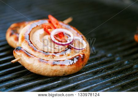 cumberland sausage, spiral pork sausage on bbq grill no flame, homemade