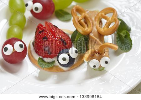Funny beetles from grapes, berries and pretzels