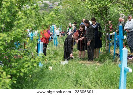 Tocuz, Moldova- 9 May, 2016: The Priest Blessing The Graves During Memorial Easter.