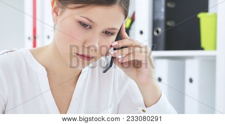 Beautiful Young Girl  Listens Attentively To The Interlocutor On The Phone
