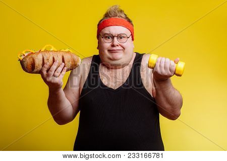 Fat Sportsman Has Ruined The Diet With Yummy Humburger. Gluttony.