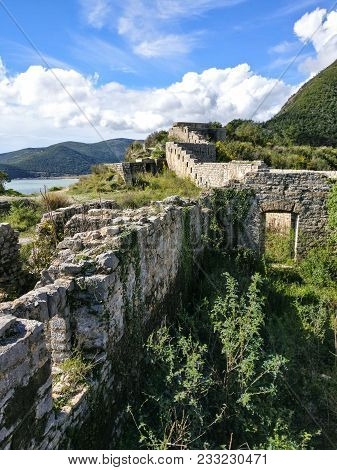 Ruins Of Medieval Fortress Mogren At The Shore Of Adriatic Sea. Historic Attractions Of Budva, Monte