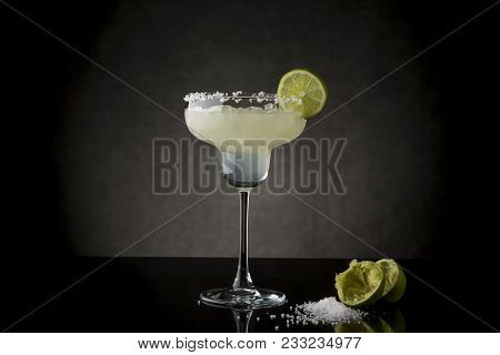 Classic Lime Margarita Cocktail With Tequila, Triple Sec, Lime Juice, Crushed Ice And Some Salt On T