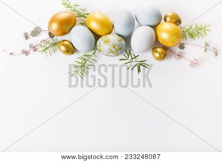 Easter Background With Easter Blue And Gold Eggs On White. Top View, Flat Lay With Copy Space