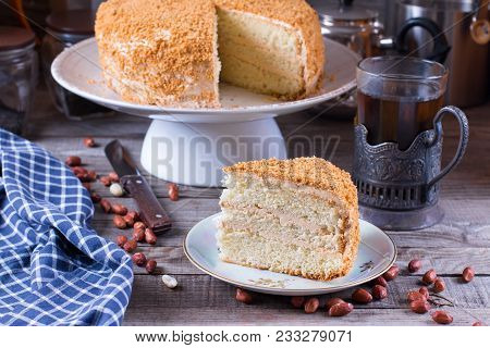 Homemade Biscuit Cake With Sour Cream On A Wooden Table