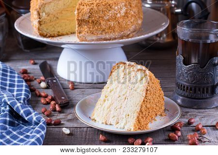 Homemade Biscuit Cake With Sour Cream On A Wooden Table