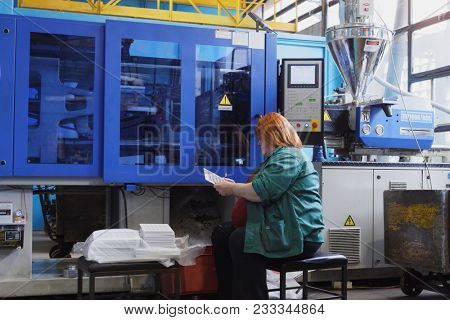 ST. PETERSBURG, RUSSIA - MARCH 15, 2018: Female worker at work in the plastics recycling plant named after newspaper Komsomolskaya Pravda. The plant produces plastic products since 1931