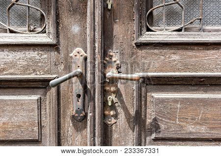 Old Wooden Door Of A Shabby Demaged House Facade. A Small Town In The Mountains Of Slovenia, Europe