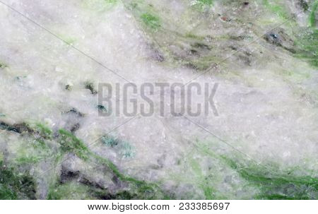 grey and green listvenite mineral texture closeup