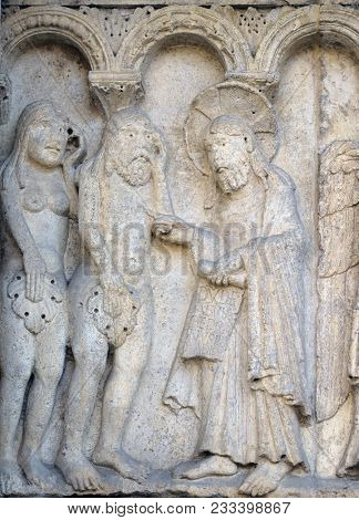 MODENA, ITALY - JUNE 04: The Rebuke of Adam and Eve relief by Wiligelmo, Modena Cathedral, Italy on June 04, 2017.