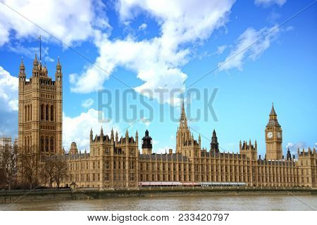 The Thames River With The Houses Of Parliament And Big Ben Clock Tower In London.