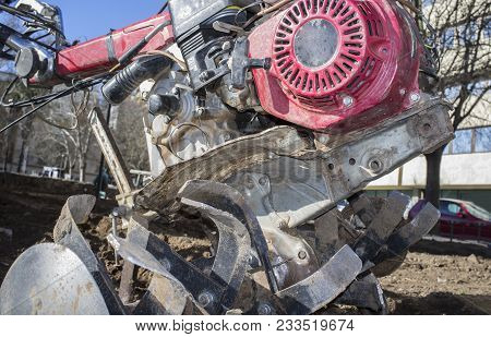 Detail Walking Tractor Equiped With Plow At Urban Park Ready To Work