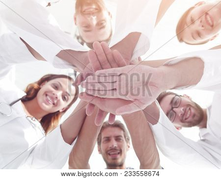 bottom view.a team of doctors at the medical center clasped thei