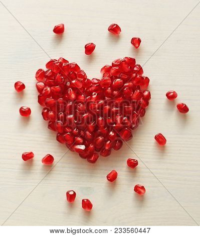Red Heart Of Grenades. Big Ripe Red Granets Or Garnets. Fruits Of Red Ripe Pomegranate On The White 
