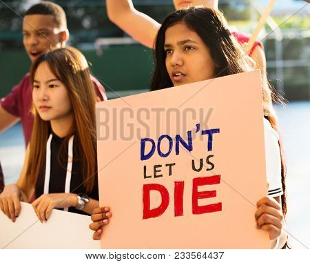 Group of teenagers protesting holding posters saying don't let us die antiwar justice peace concept