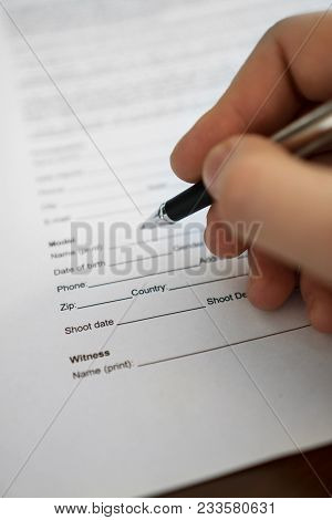 Man Is Signing Model Release For Microstock.