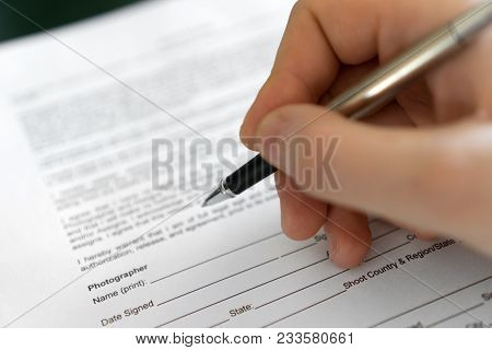 Man Is Signing Model Release For Microstock.