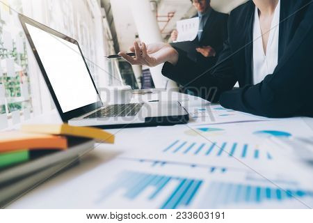 Business Team Work Brainstroming Meeting Process. Business People Discussing The Charts And Graphs S