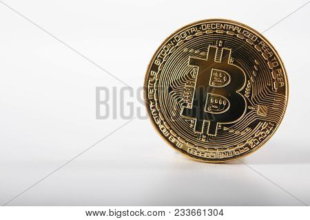 Golden Bitcoin On Isolated On White Table. A Visual Representation Of Digital Cryptocurrencies. Bitc
