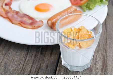 Close Up Breakfast Set With Bacon Fried Egg And Ham On Wooden Table Background