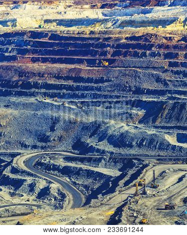Multicolored Layers Of Rock In An Open Pit Mining Iron Ore