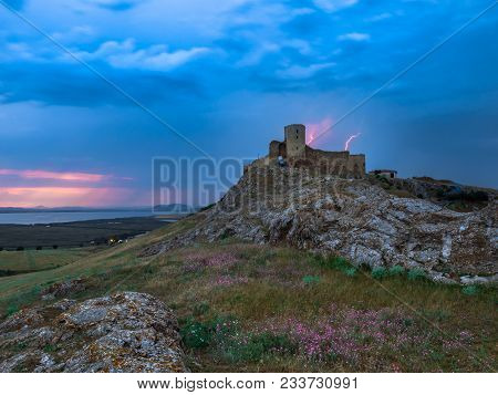 Thunderbolts,lightning On A Cloudy Evening Blue Sky Over Old Enisala Stronghold,citadel, Dobrogea, R