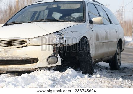 Car Accident On A Mountain Forest Road. Turned Upside-down The Broken Car Pulled Off The Road And Fe