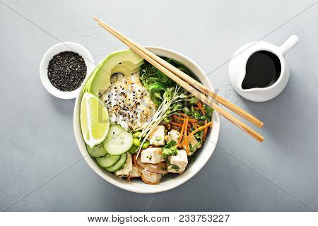 Poke Bowl With Silken Tofu, Seaweed, Rice And Vegetables
