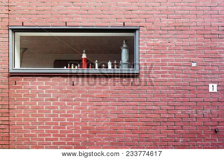 Physical Models Of Lighthouses In The Window And Brick Wall