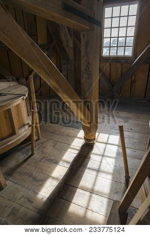 Interior Of A Historic Wooden Mill With A Detail Of An Old Wooden Crusher In The Area With Beautiful