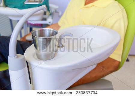 Glass Chromium On Sink Medical Equipment Dentist Close Up, Ceramic Spittoon And Water Filler In Clin