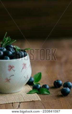 Fresh Ripe Wild Blueberries Heap In White Bowl. Fresh Blueberry On Wood Table In Vertical With Copy 