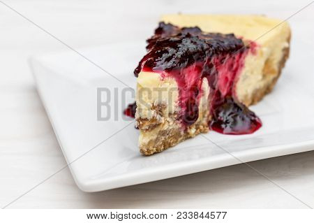 Piece Of Heesecake With Jam On Saucer.