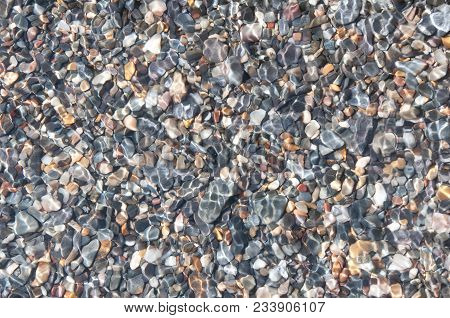 Reflection Of The Sun On The Stones In Shallow Water