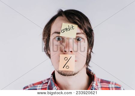 Stickers With The Inscription Credit And Percentages Pasted On The Forehead Of The Man And The Mouth