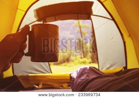 Traveling And Spending Time In Tent While Drinking Coffee In The Morning. View From Inside. Camper H