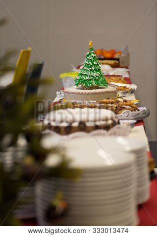 Simple Cake Dekorated With An Eatable Christmas Tree Pops Out Amonst Other Pies And Cakes On A Chris