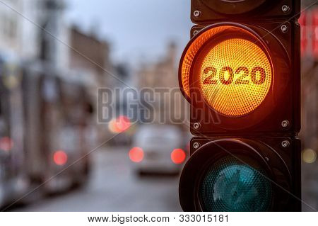 A City Crossing With A Semaphore. Orange Light With Text 2020 In Semaphore. Symbolic New Year Approa