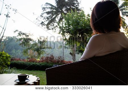 A Beautiful Young Woman Drnking Tea And Relaxing In The Morning