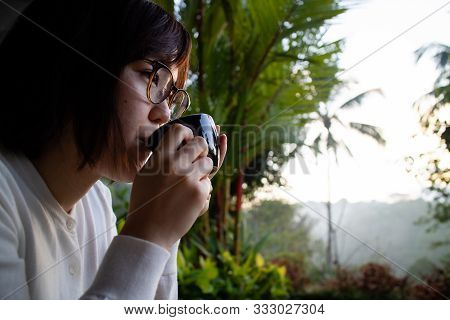 A Beautiful Young Woman Drnking Tea And Relaxing In The Morning